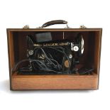 A Singer sewing machine in hard carry case, serial no. EC142919