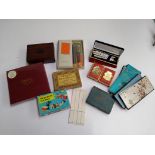 A mixed box of playing cards and games to include Bezique, bidge sets, pens, etc