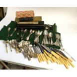 A quantity of plated flatware, some in green felt, to include dessert forks and spoons; various