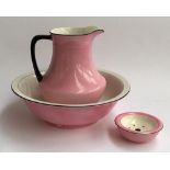 A pink ceramic washbowl, 40cmD, jug and soap dish (af)