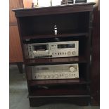 A mahogany music cabinet, the door opening to reveal three shelves, 54x48x82cmH containing Hitachi