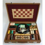 A cased games set including roulette, chess, draughts etc; together with a wooden chessboard