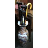 A 20th century Oriental vase containing a quantity of walking sticks, the vase 60cmH