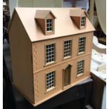 A modern dolls house, with various doors and fittings, 62cmW