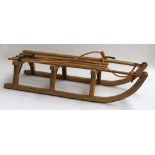 A vintage wooden sledge with steel runners