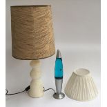 A 1970s ceramic table lamp with shade, 76cmH; together with a blue lava lamp and one other lampshade