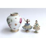 A Dresden hand painted porcelain vase 17cm high; together with two figurines of lace-dressed