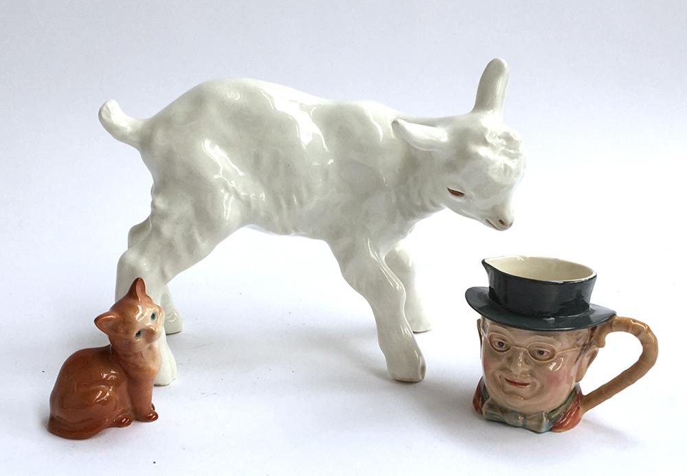A large pottery lamb figurine marked USSR 24cm long 18cm high; together with a Beswick cat and
