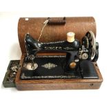 A Singer sewing machine, with spare parts, serial no. Y2314588, in a hooped oak carry case