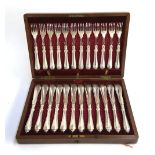 A mahogany canteen of plated fish knives and forks for 12 place settings