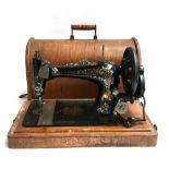 A Singer sewing machine, serial no. 9689659, in hooped mahogany carry case