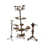A wrought iron floor standing candle holder, 16 spikes, 66cmH; together with two others