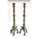 A pair of turned wooden floor standing candlesticks, 80cmH