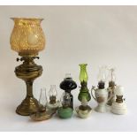 A mixed lot of nine small oil lamps; together with one larger, 50cmH