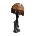 A large 20th century figural nude table lamp, with tasseled shade, 76cmH including shade