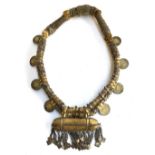 An Omani decorative white metal necklace, the neckline decorated with six silver thalers inset