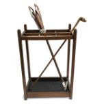 An oak stick stand, divided into six sections, with drip tray, 68cmH; with shooting stick etc