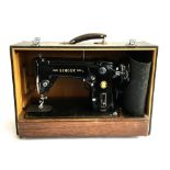 A Singer 306K electric sewing machine, with mat and pedal, in hard case