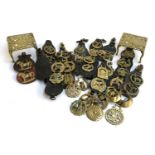 A very large lot of horse brasses, some mounted, together with two brass trivets, each 15cm2