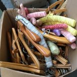 A large box of various beechwood clothes and skirt hangers