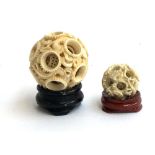 Two Chinese carved ivory concentric puzzle balls, each depicting dragons, the larger approx. 5cmD, t