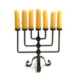 A wrought iron seven arm candlestick, with candles, 44cmW