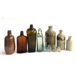 A mixed lot of vintage bottles and stoneware jars