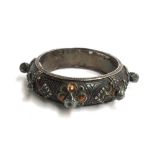 Persian heavy white metal slave bangle with some faded enamel decoration
