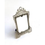 A pierced silver framed mirror, marked 830, with shaped bevelled plate, 20cmH 12.5cmW