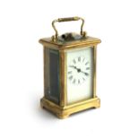 A French gilt metal mantel clock with key, enamel dial with roman numerals, 11cmH