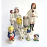 A collection of 19th century Staffordshire figurines, to include a woman holding a child and sheaf