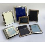 A chased silver photo frame, internal dimensions 9.5x14cm, together with eight further plated