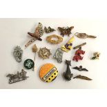 Mixed lot of badges and brooches to include one of a Saw Whet owl, RAF, scottie dogs , Siamese cat