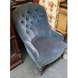 A low buttonback salon chair on turned legs and casters