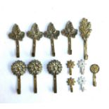 Various brass wall hooks, with leaf and rosette terminals