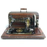 A Nelsons sewing machine, serial no. 357834, in mahogany carry case