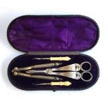 A cased set of silver plated grape scissors and nutcrackers and hooks