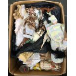 A mixed box of dolls, ornaments and wooden carvings