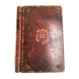 A large 19th century leather bound postcard album, with brass studs, gilt embossed monogram 'E.P' to