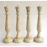 A lot of four turned wooden candle sticks, approx. 45cmH