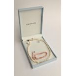 Pearl necklace and pink pearl bracelet with silver clasps in an Elements box