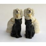 A pair of Staffordshire dogs 26cmH; together with a pair of black Sylvac cats, 17cmH