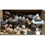 A box of various turned wooden and ceramic knobs