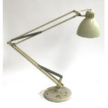 A large white anglepoise lamp, on circular base