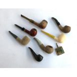 A collection of seven pipes; together with a small folding ashtray