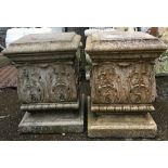 A pair of composite stone plinths with acanthus detail, each 45cmH