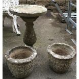 A composite stone bird bath, 62cmH; together with two planters, 24cmH