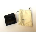 A black leather purse in Bally cotton bag