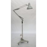 A floorstanding anglepoise lamp marked Luxo, Norway, on a three wheeled heavy base with three