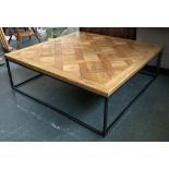 A large parquet style coffee table on welded metal support, 126cm2 40cmH